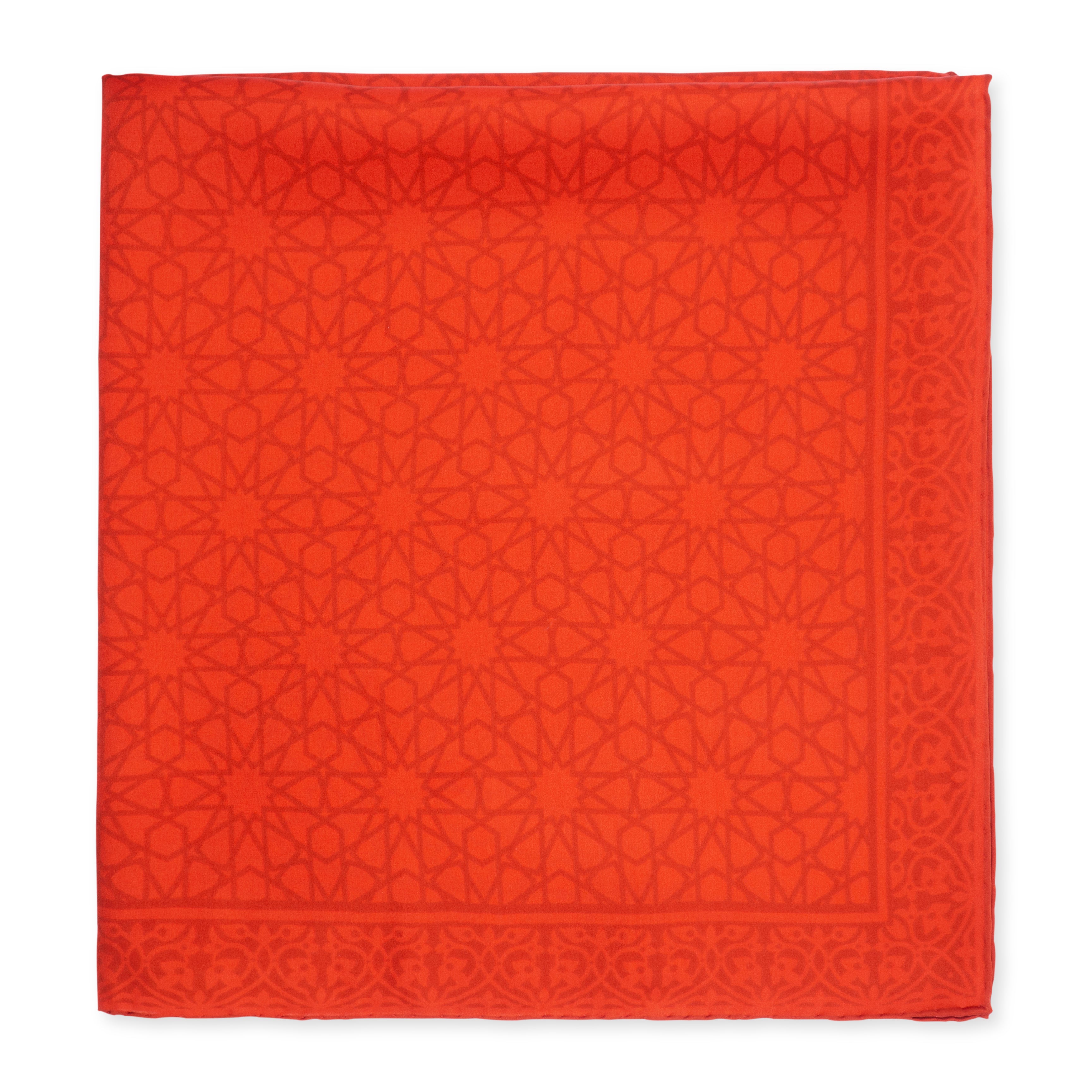 The Red Silk Square Scarf Dalila is handcrafted in Turkey from satin silk, featuring an intricate geometric star and lattice pattern with a decorative border accentuating its square shape.