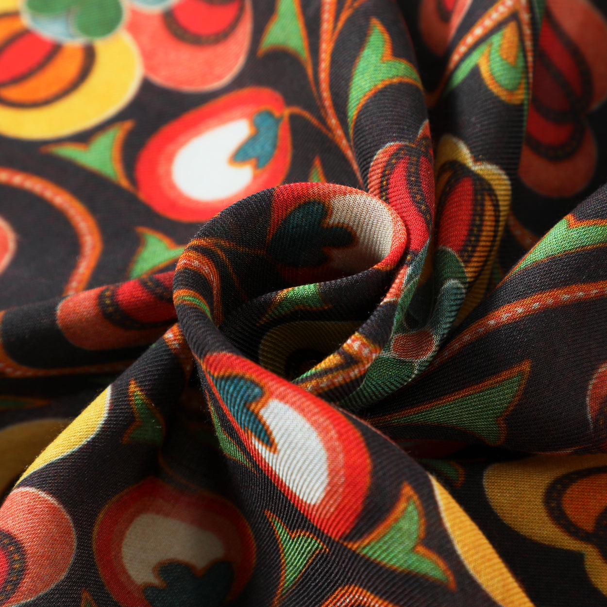 A close-up of the Saroyi Floral Black Scarf, featuring Isfahan-inspired floral and fruit motifs in red, green, yellow