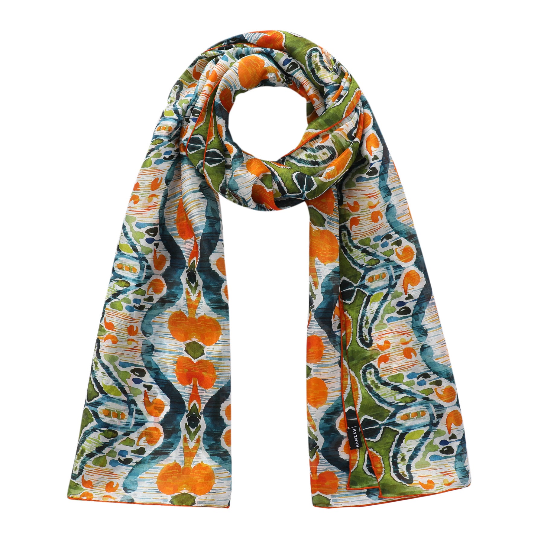 The Hamzah Green and Orange Silk Scarf features an abstract Ikat print on habotai silk, showcasing vibrant blue shapes and lines in a colorful artistic style.