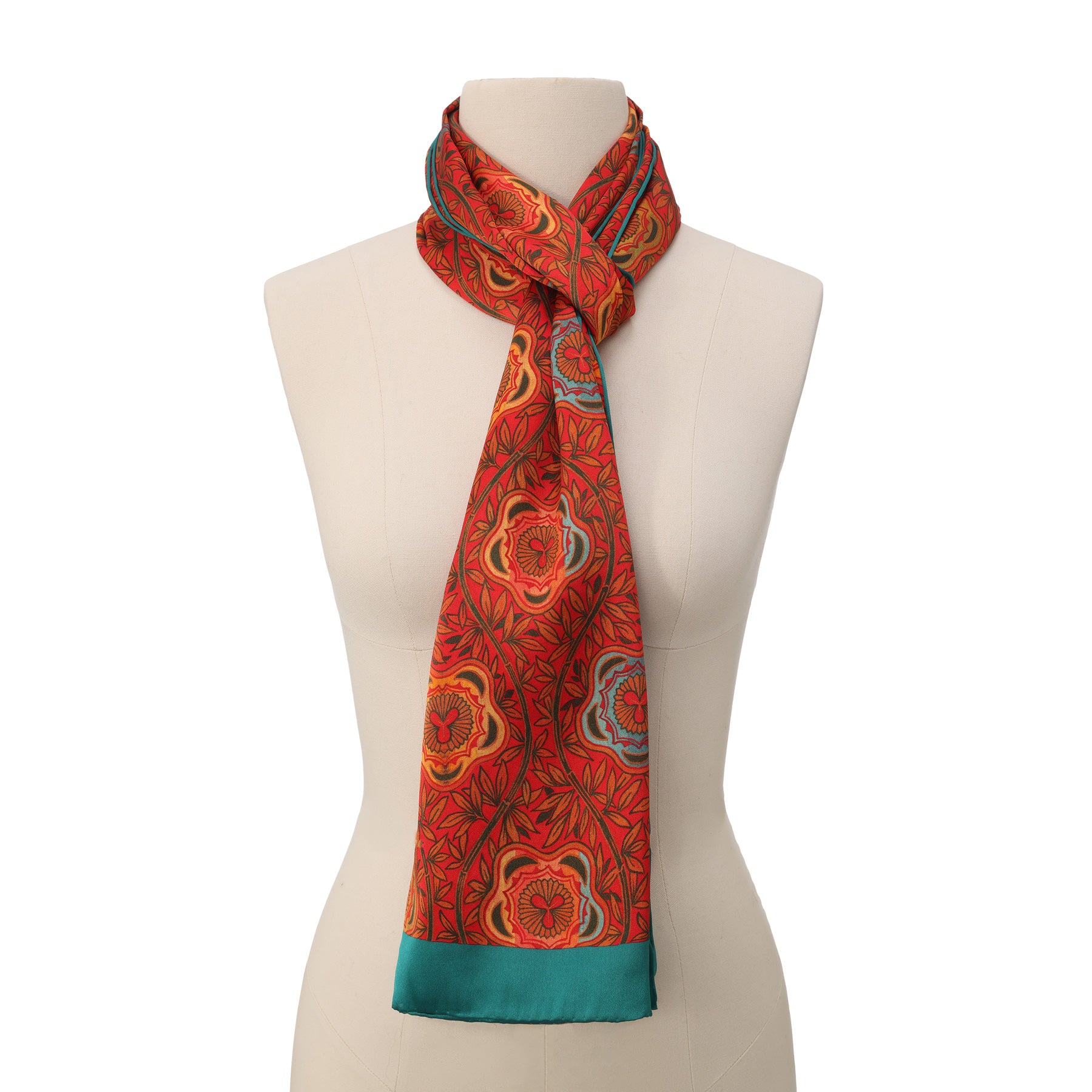 A close-up of the Red and Blue Scarf with Floral Print Marigold, softly folded to highlight its smooth texture and vibrant red and blue floral patterns.