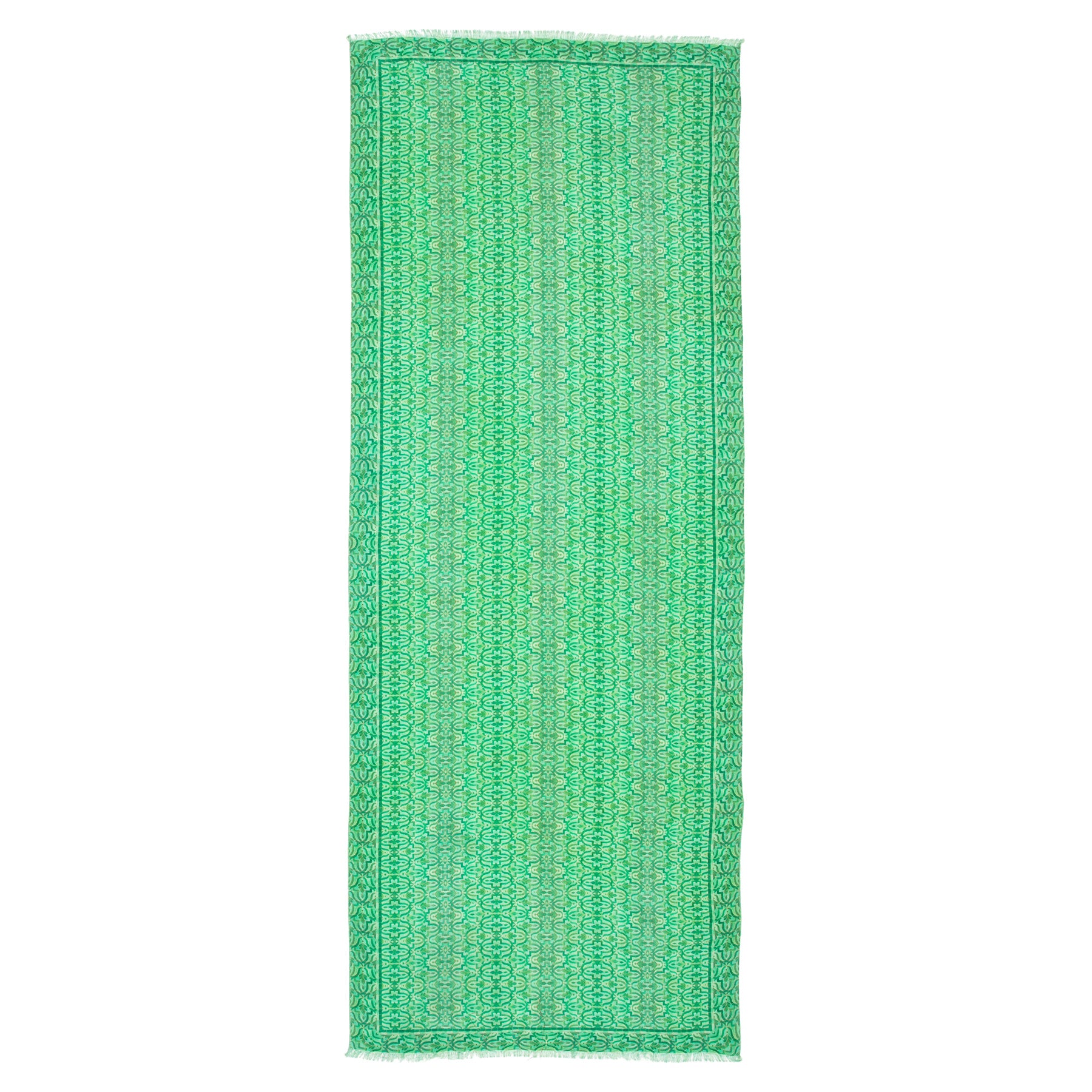 The Green Silk and Wool Scarf Ahdar is a long, rectangular scarf with a subtle geometric print, crafted from silk and wool in green, and finished with short fringe.