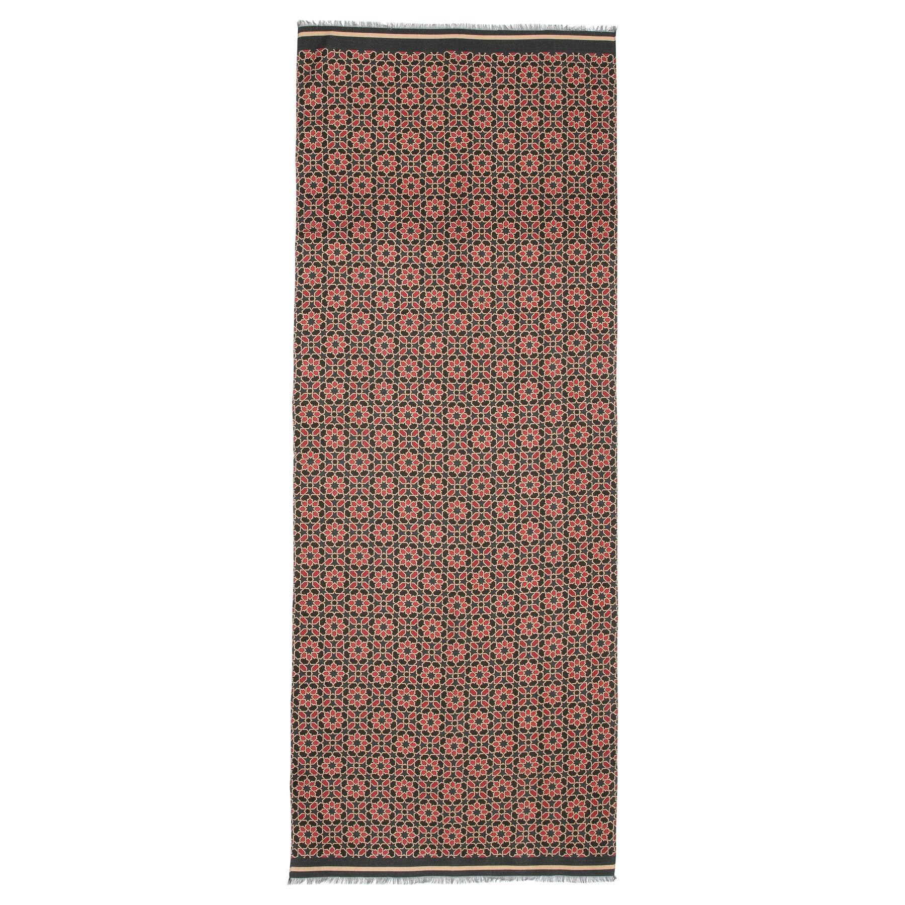 A rectangular silk wool scarf with a repeating red and blue geometric print, fringed edges on the short sides—a striking piece that captures cultural artistry.