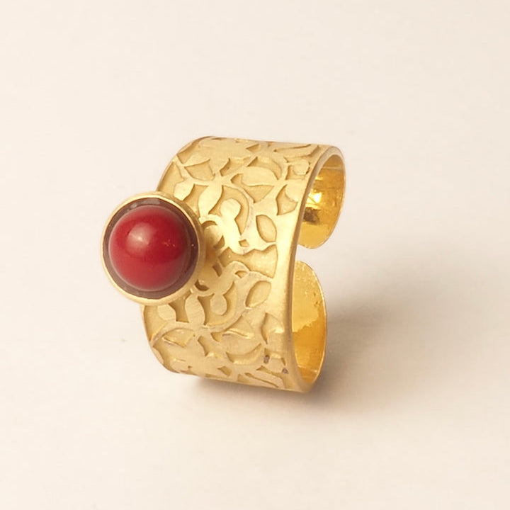 The Platónica Nasrid Palaces Detail Ring, with its intricate floral pattern and large red stone evocative of the Alhambra collection, is elegantly showcased on a plain white background.