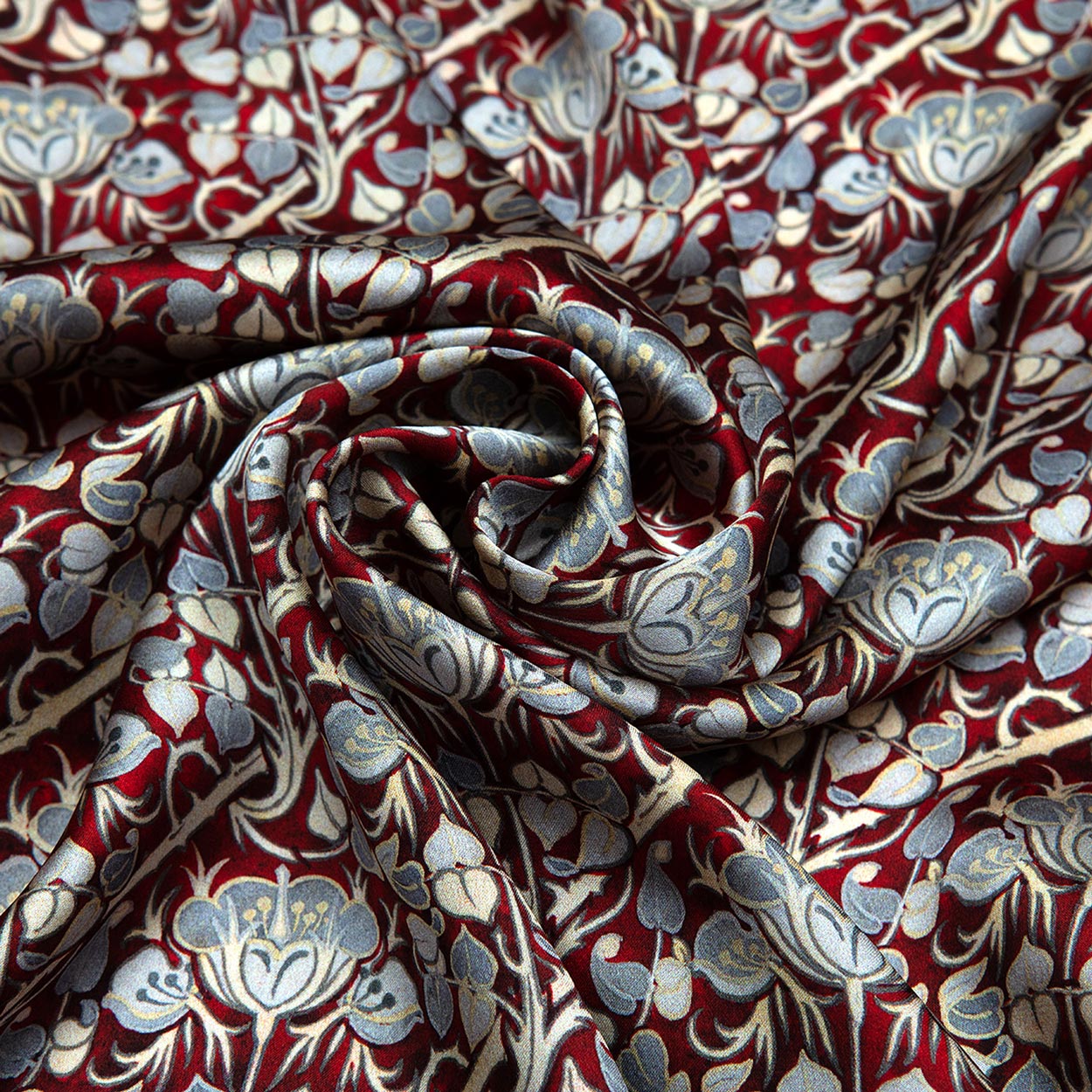 Burgundy and gray silk scarf with a Noisette roses print, featuring softly gathered folds and a spiral design that evokes the elegance of Art Nouveau.