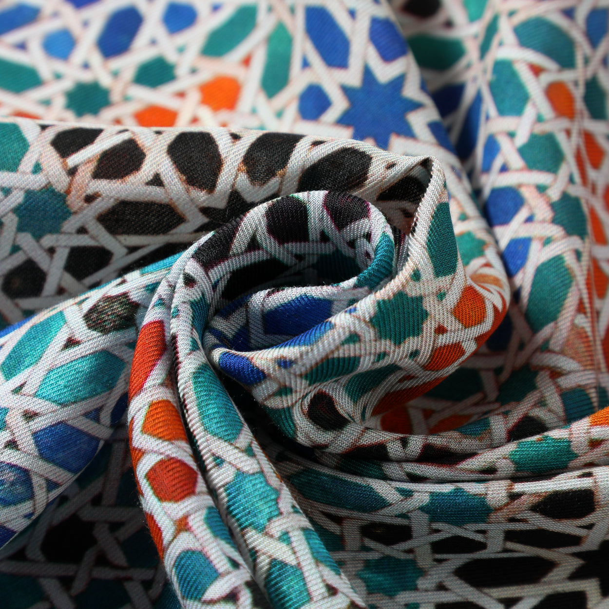 Close-up texture detail of the modal scarf with Moorish tile print.