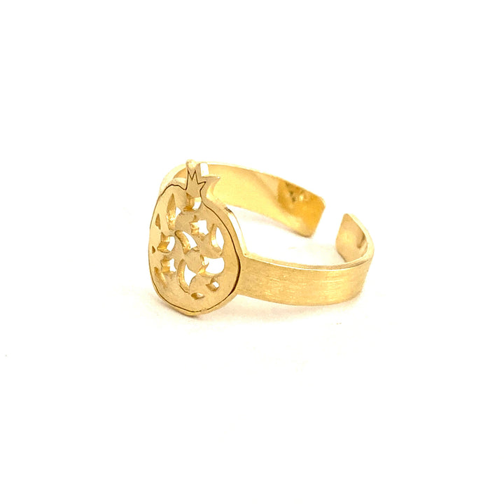 The Gold Plated Thin Ring Granada No.2 by Platónica features a handcrafted, pomegranate-shaped design on top with intricate cut-out patterns and a simple, slightly textured band, all set against a plain white background.