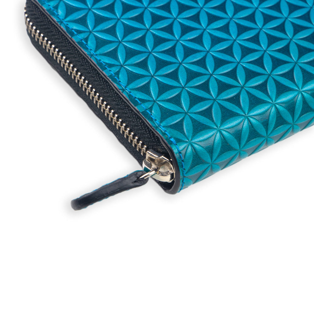 A close-up of the Large Leather Wallet with Zipper Blue by Munira Leather, showing blue embossed leather with a geometric design and a visible metal zipper pull.