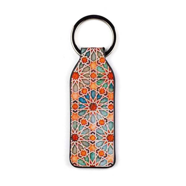 Leather keychain with orange and green print inspired by Islamic art