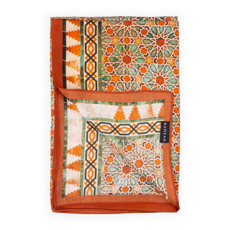 Close up of orange scarf with islamic art geometry print