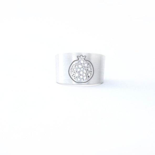 The Platónica Sterling Silver Wide Ring Granada No.4 features a handcrafted sterling silver wide band embossed with a pomegranate design, beautifully set against a plain white background.