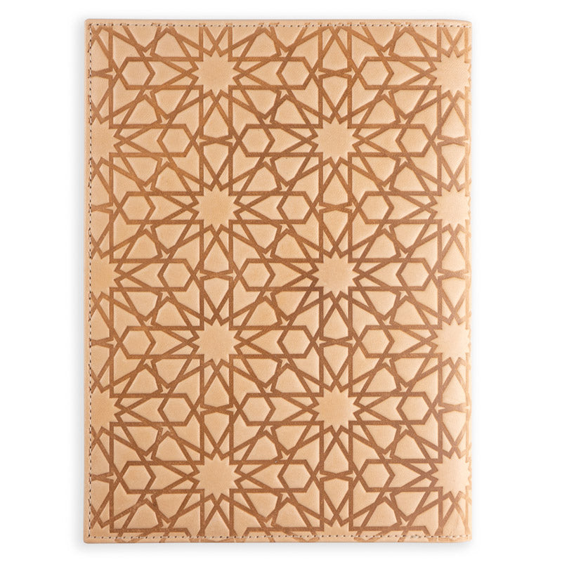 The Munira Leather Na’layn Leather Journal Cover Natural is a tan full grain leather, refillable cover embossed with an intricate geometric pattern inspired by Islamic art, giving it a textured and decorative look.