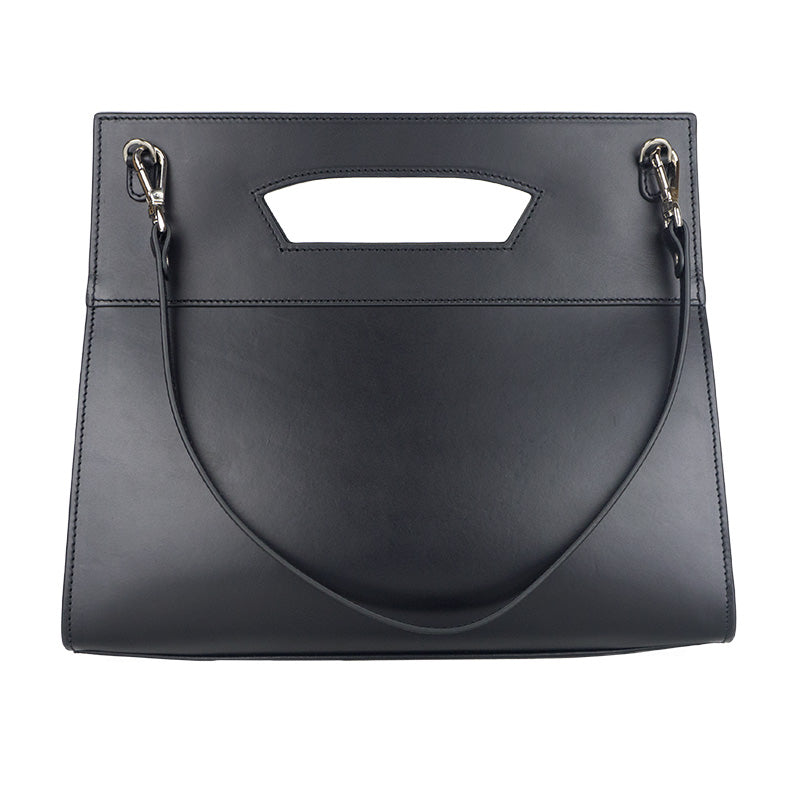 The Munira Leather Leather Bag Lisboa Nazarí is a sleek black handbag crafted from Spanish leather with a rectangular shape and cut-out handle. It features silver hardware, a detachable strap, and embodies minimalist design.