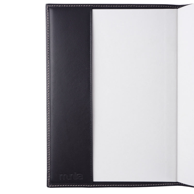A natural full grain leather journal cover by Munira Leather, shown open to reveal a blank white interior. The Munira Leather logo is embossed in the lower left corner—a stylish refillable cover for your Na´layn notebook.