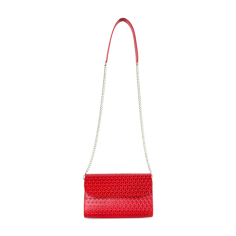 Red small leather shoulder bag with metal and leather strap and flower of life pattern embossed
