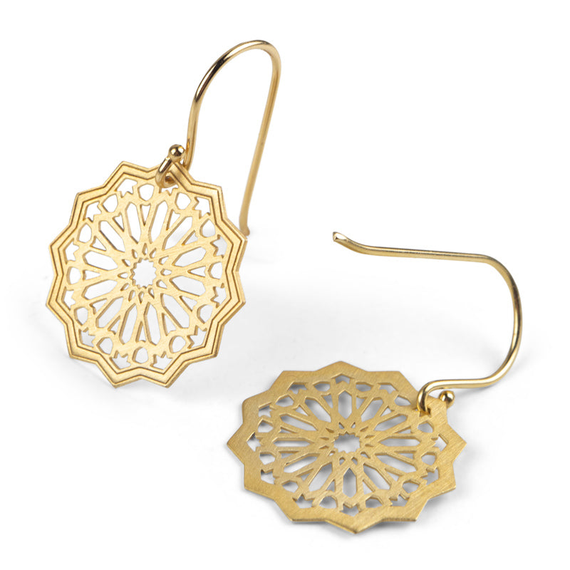 Introducing Platónicas Gold Plated Sterling Silver Earrings Estrella from the Andalusi Collection. Handmade in Granada, these exquisite earrings feature intricate geometric designs inspired by rose windows and dangle from simple hooks, showcasing delicate cut-out patterns that reflect outstanding craftsmanship.