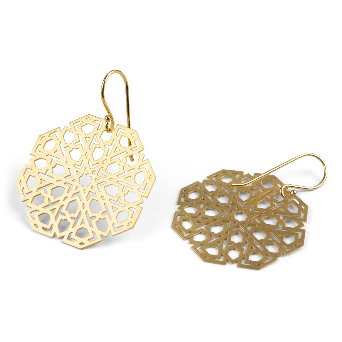 From the Platónica Mudéjar Collection, these Gold Plated Sterling Silver Earrings Mudejar Big feature intricate geometric patterns. One stands upright with a visible hook, and the other lies flat, showcasing their lace-like design on a white background. Handmade by local artisans.