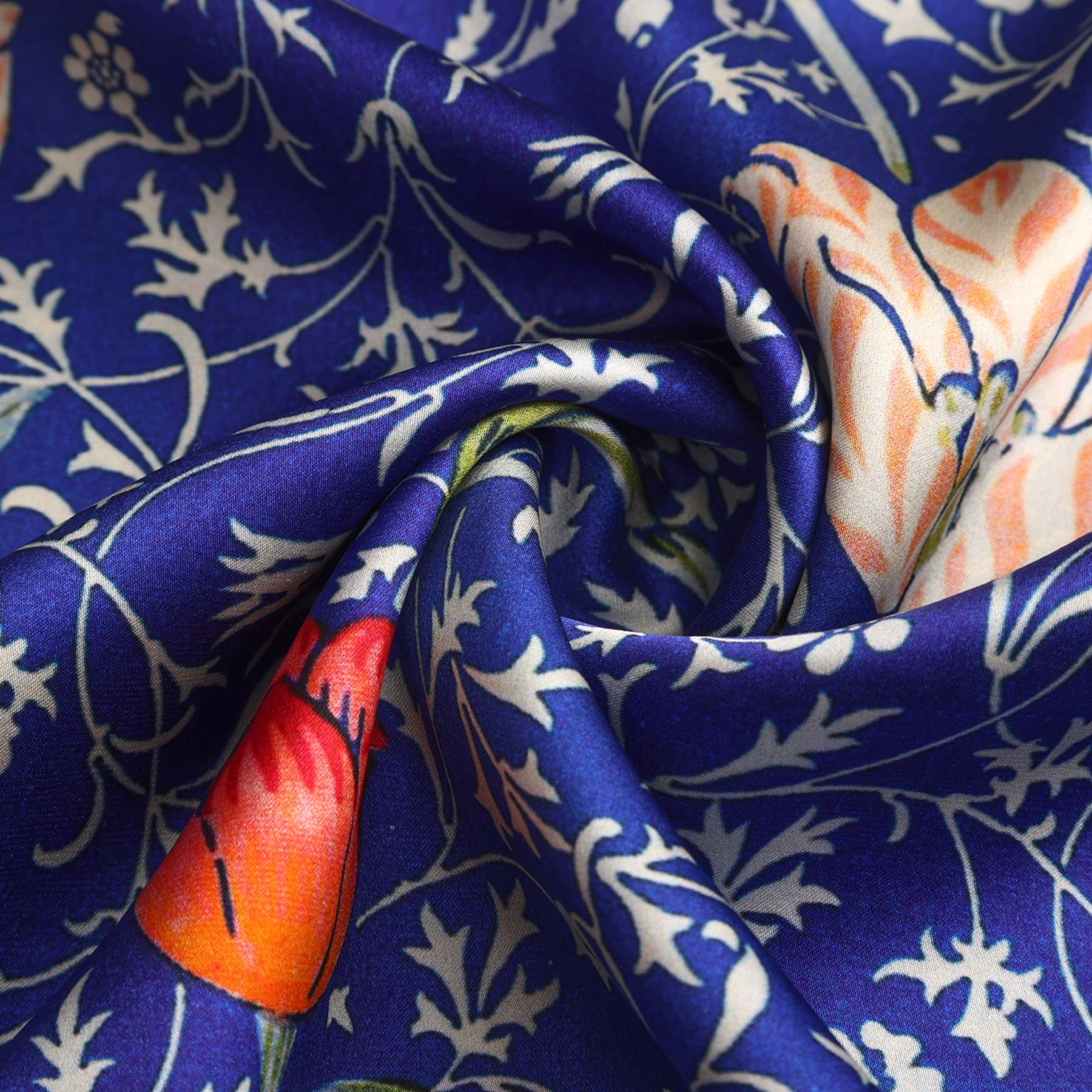 The Floral Blue Silk Scarf Galata features a smooth, silky texture with Art Nouveau-inspired orange, green, and white floral