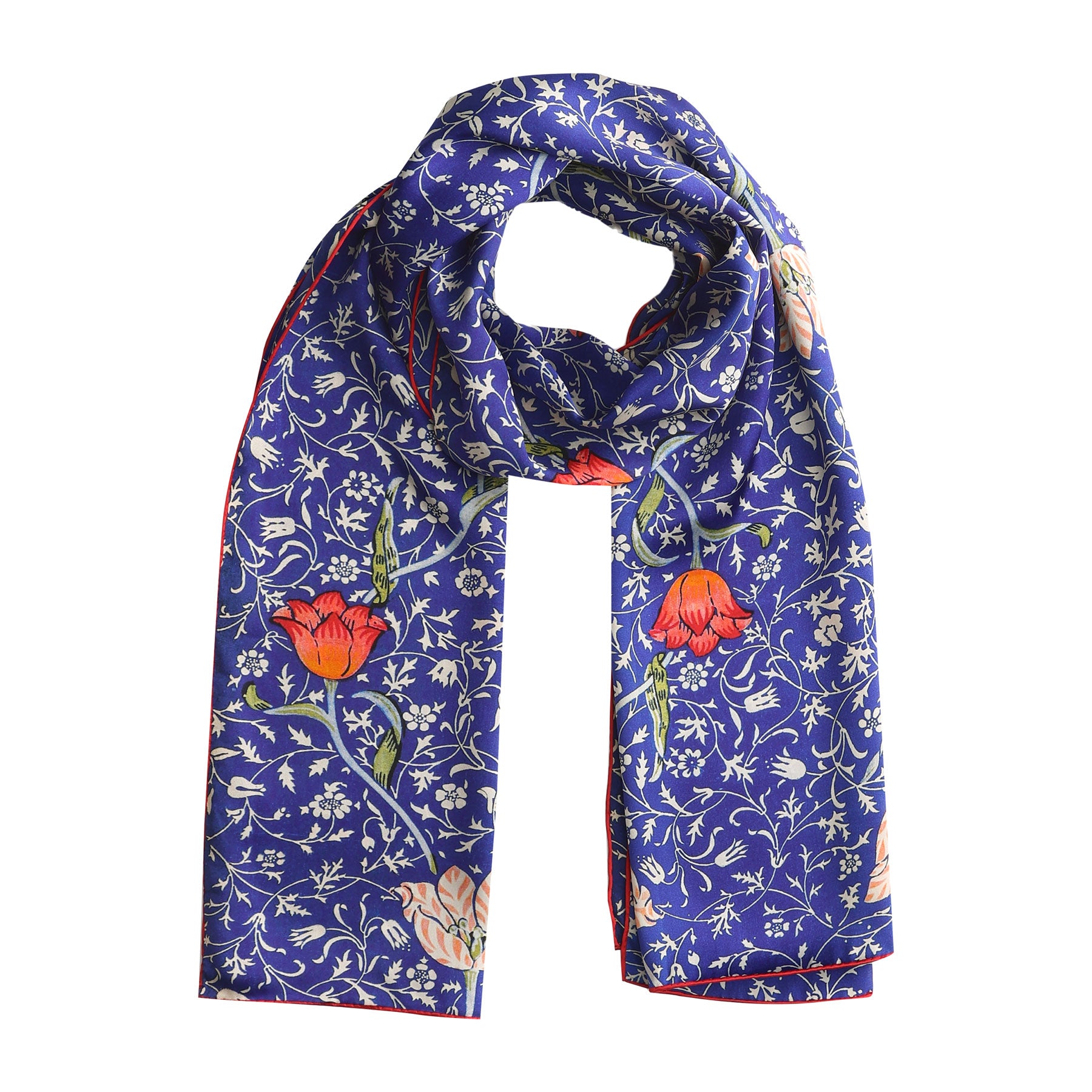 The Floral Blue Silk Scarf Galata features an Art Nouveau floral pattern with red and orange flowers, green leaves, and white vines decoratively arranged on luxurious blue silk.