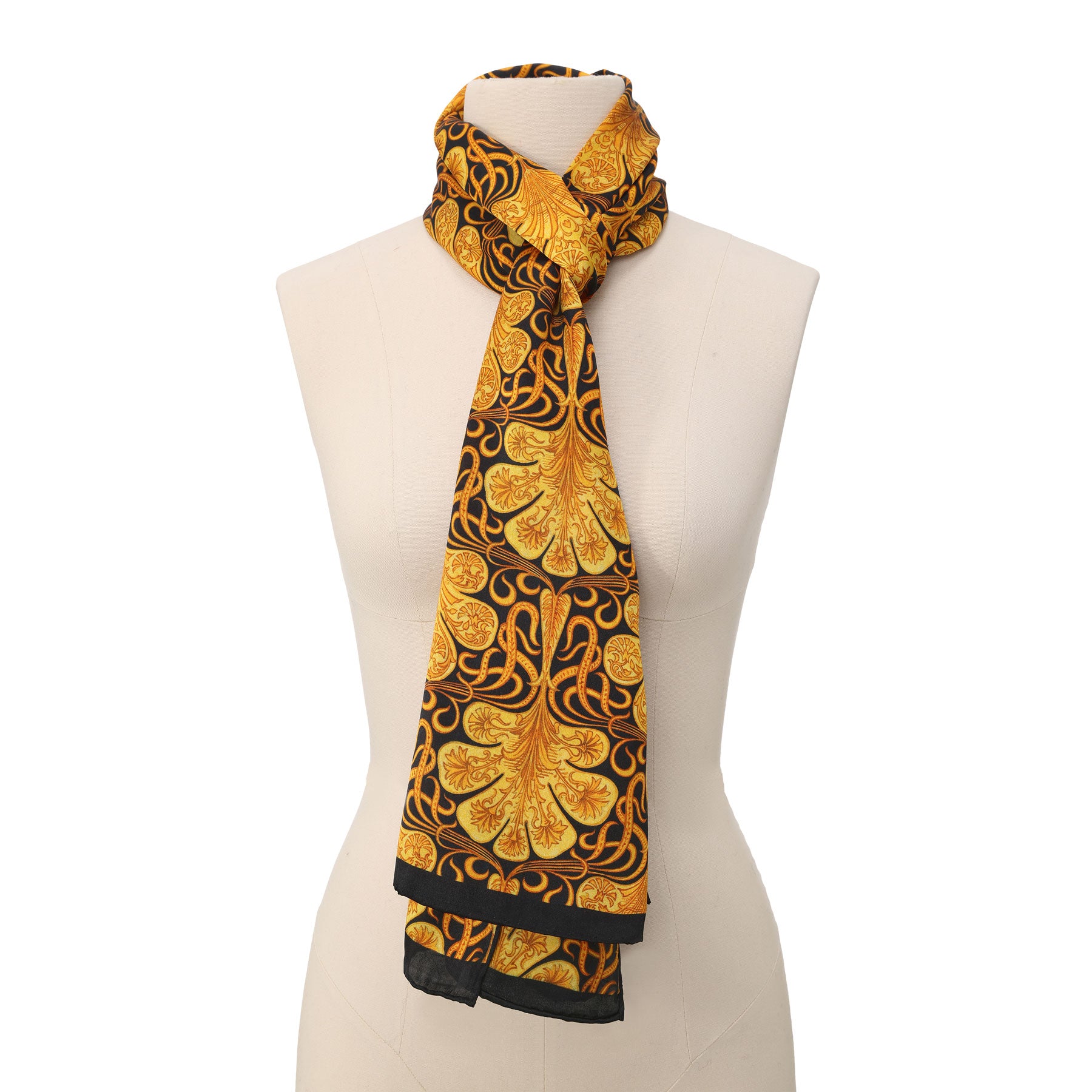 A close-up of the Black Silk Scarf with Ornate Gold Pattern Reims shows its luxurious silk, gathered in soft folds