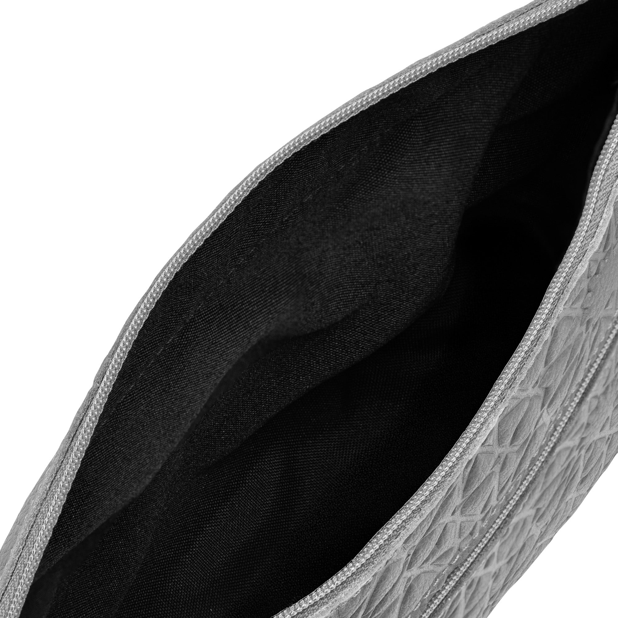 Close-up of the inside of the Gray Embossed Crossbody Bag with Islamic Design Pattern (Copia), showing its textured exterior and black fabric lining.