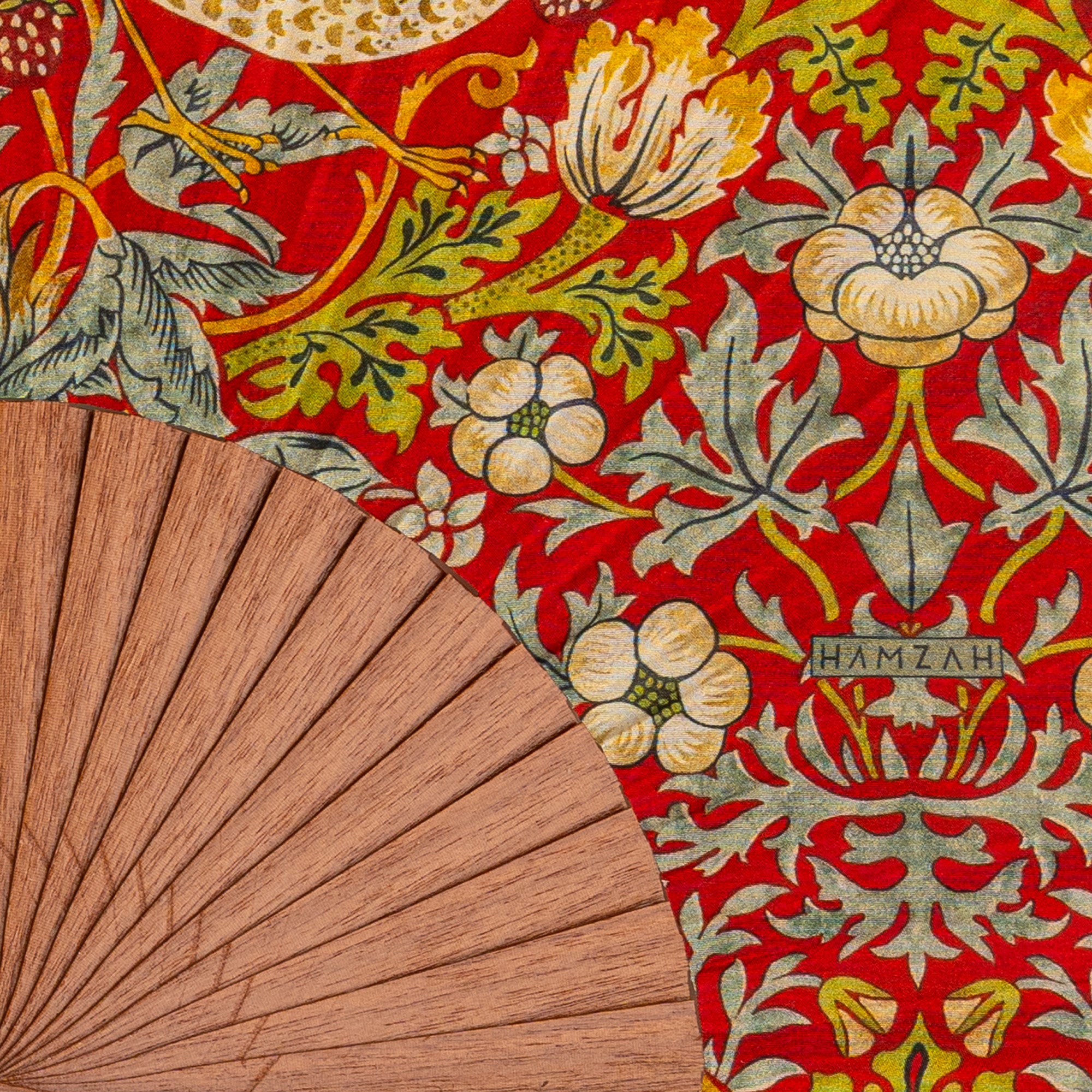 Close-up of the William Morris Print Hand Fan Birds showing the William Morris Strawberry Thief print in detail.