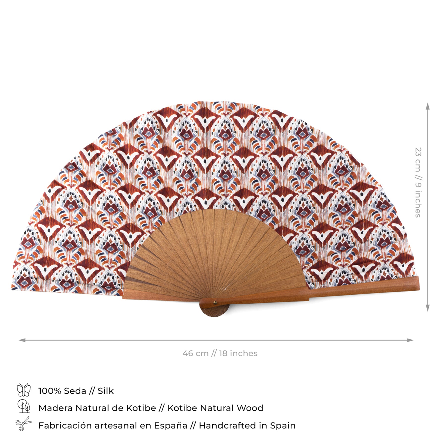 The Ikat-Inspired Silk Fan is handcrafted in Spain from bocapi wood, featuring a red, white, and blue geometric floral pattern. Measuring 46 cm wide by 23 cm tall, this stylish accessory adds decorative flair to any setting.