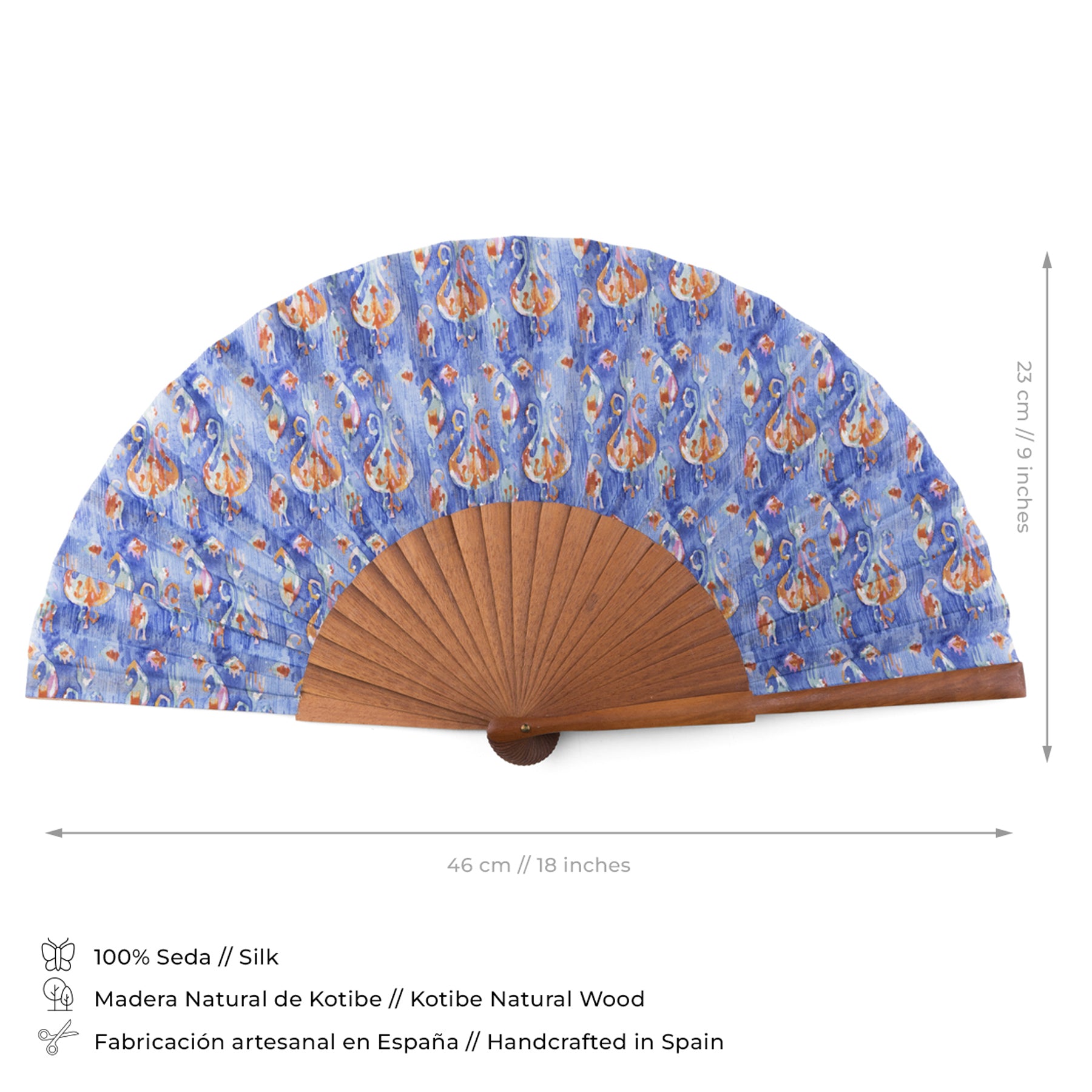 The Blue and Orange Handcrafted Ikat-Inspired Silk Fan features premium silk with a blue Ikat design, a natural wood frame, and measures 46 cm x 23 cm. Showcases exquisite Spanish craftsmanship with icons for silk, wood, and artisan quality.