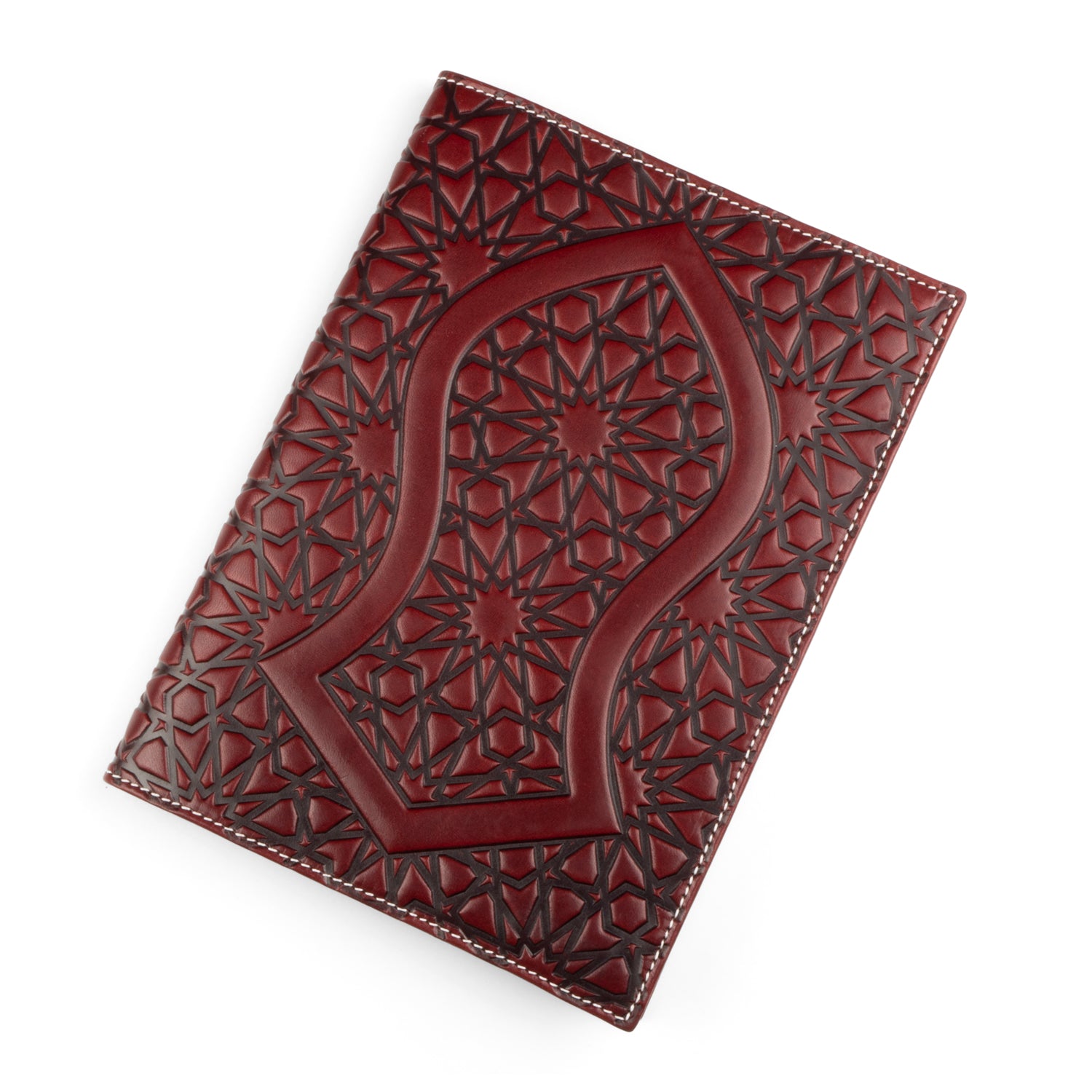 A burgundy leather notebook cover with an embossed design inspired by the sacred Nalayn, the sandal of the Prophet Muhammad (SAW). The intricate geometric pattern adds depth, framed by a neat white stitched border.