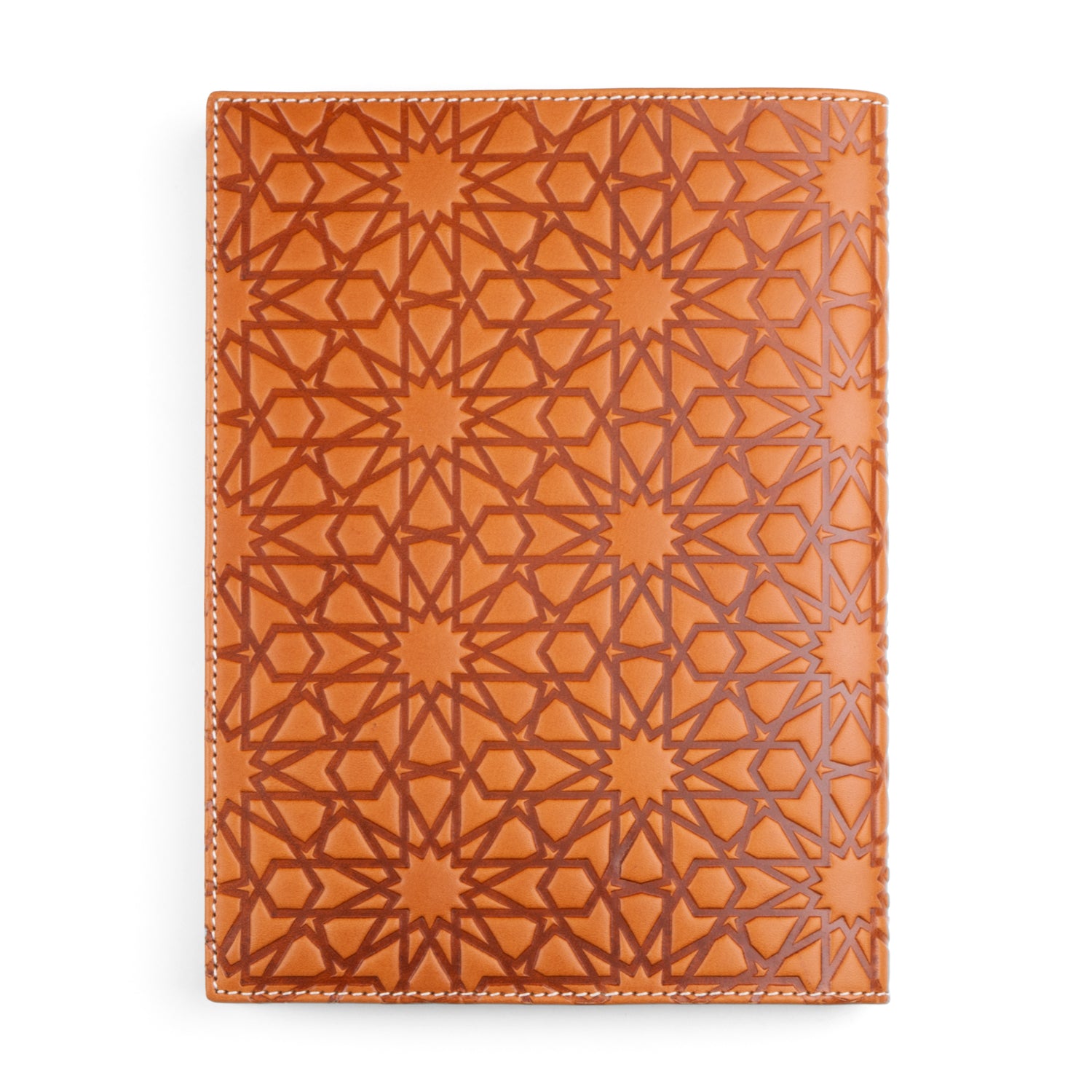 A tan leather notebook cover embossed with a geometric pattern inspired by Islamic art, featuring a repeating motif of stars and polygons. The high-quality leather is bordered with clean white stitching.