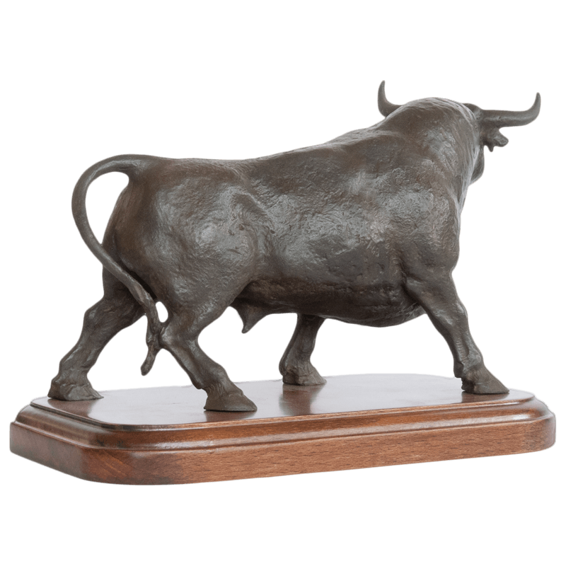 Back view of bronze sculpture of large bull on top of a wood base