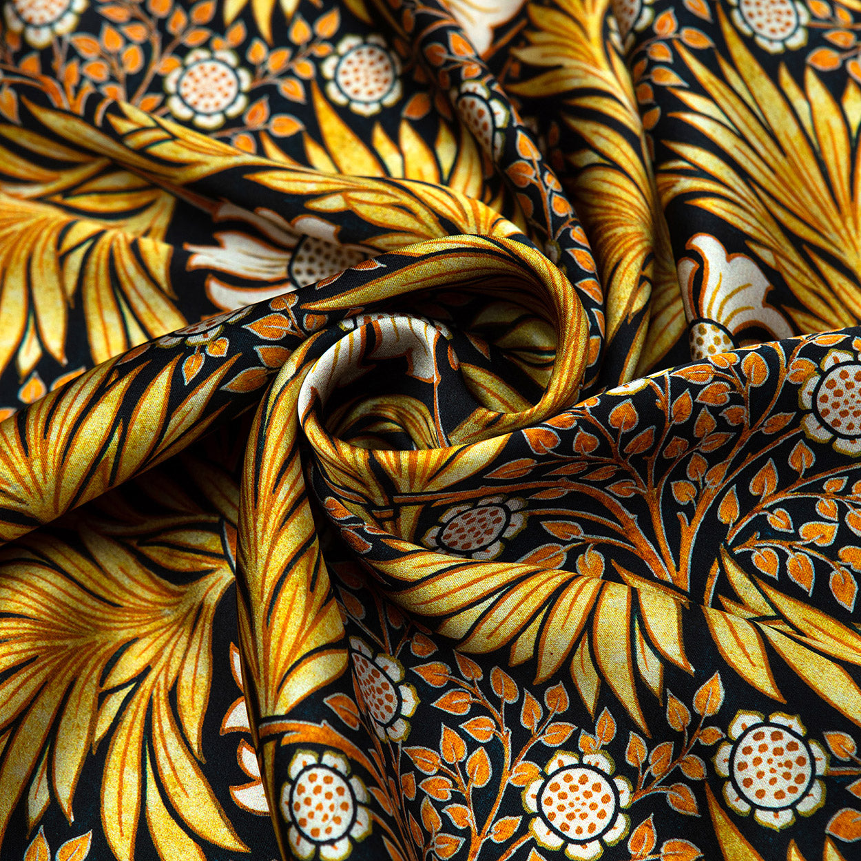 Swirled black scarf featuring shimmering gold foliage and delicate white flowers on a silky background.