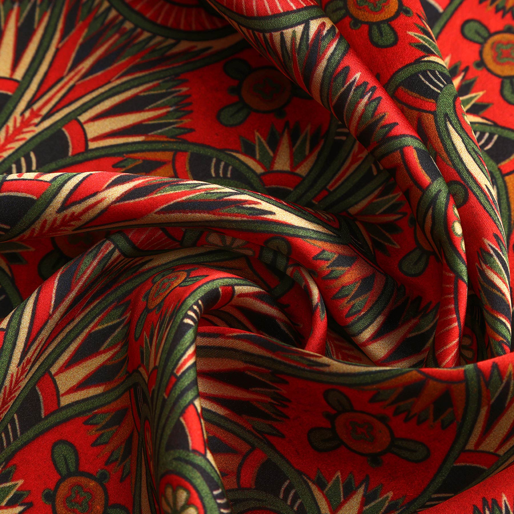 Close-up of the scarf’s dark hem, revealing green vines and gold floral accents on a crimson art nouveau pattern.