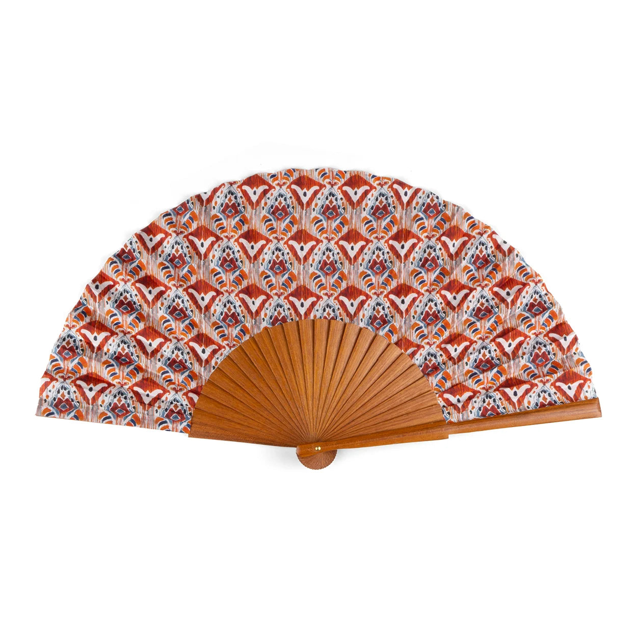 A handcrafted silk fan with a vibrant Ikat-inspired design in orange, red, and blue tones, paired with a sturdy Bocapi wood handle. The fan is 23 cm wide when opened, and it is handmade in Valencia, Spain.
