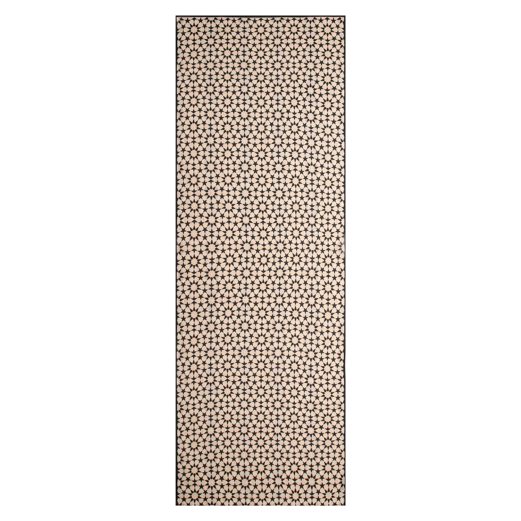 The Beige and Black Scarf - Sahara features a rectangular shape with a repeating pattern of small black stars on beige, inspired by the geometric lattice designs of Andalusí Islamic art.