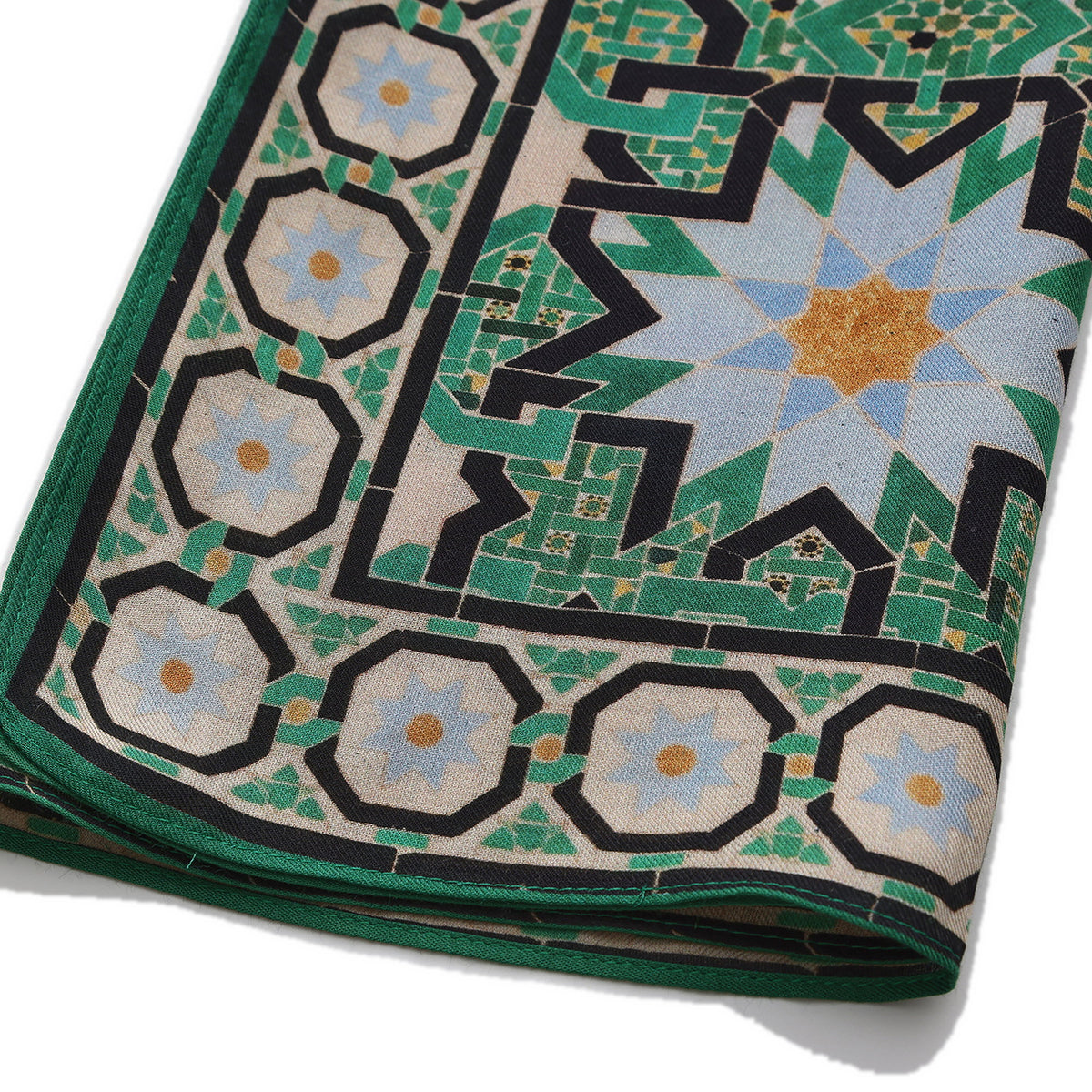 Folded corner of the Green Modal Scarf Alhambra Interlace Salma, showing the border and the hem