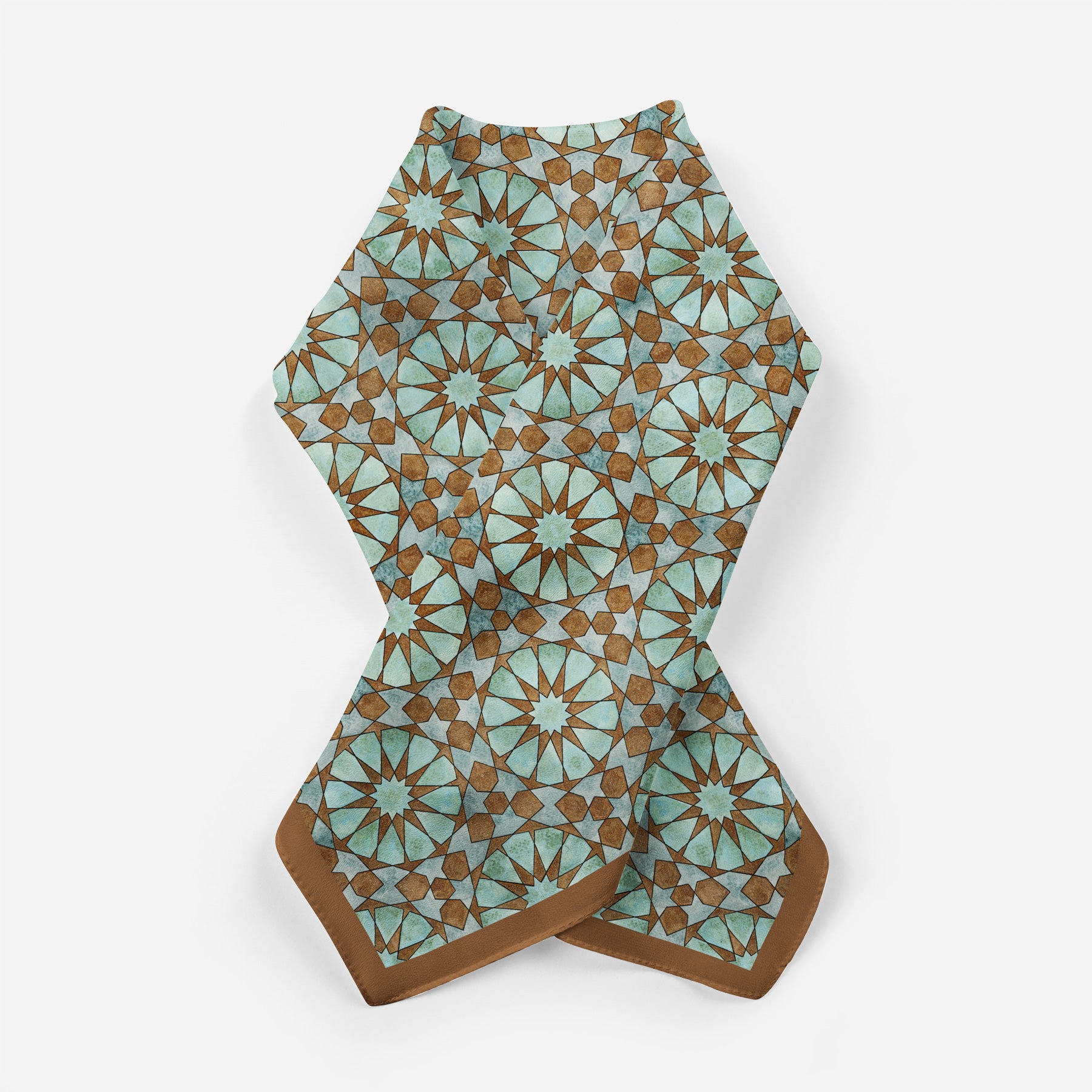 The Brown Silk Neckerchief for Women features a geometric pattern of teal and brown stars and polygons, inspired by Islamic art, with a solid brown border. It's displayed on a white background.