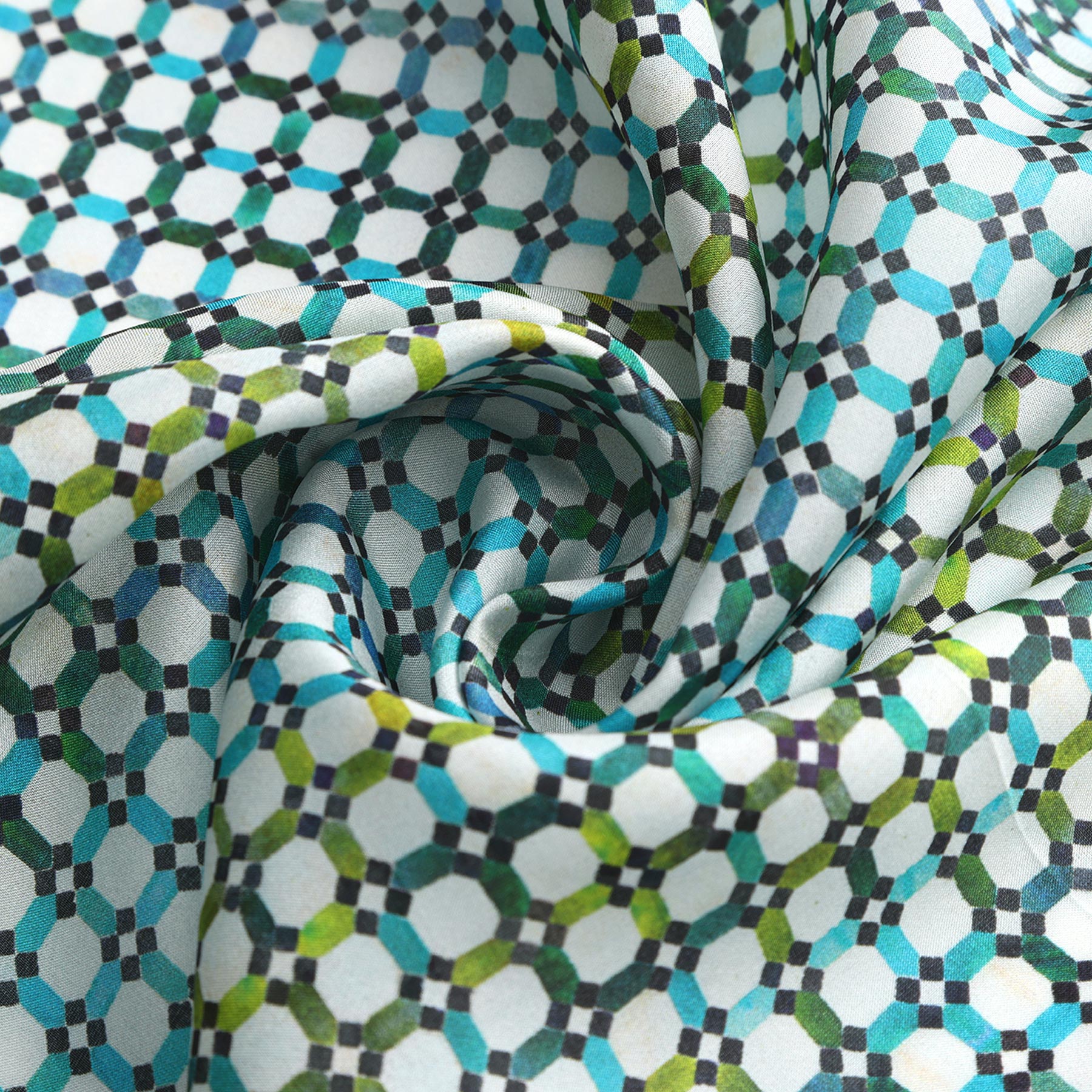 A close-up of the Coloful Neckerchief 100% Silk, draped in soft folds and twisted into a spiral, showcases its geometric hexagon and circle pattern in blue, green, and white—designs inspired by Islamic art.