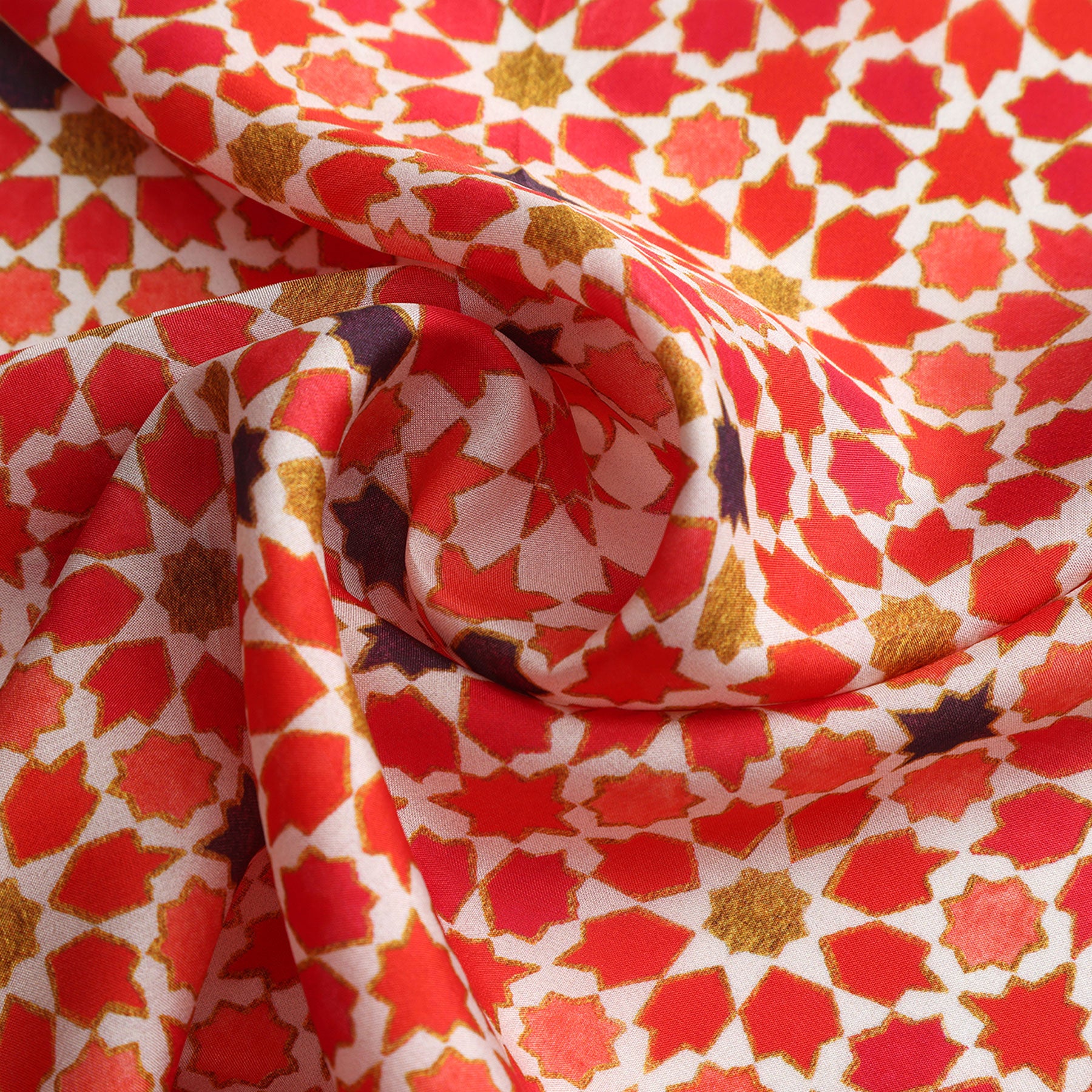 The Small Square Scarf Alhambra features a red and white fabric adorned with an intricate Islamic art print, highlighting exquisite Spanish craftsmanship.