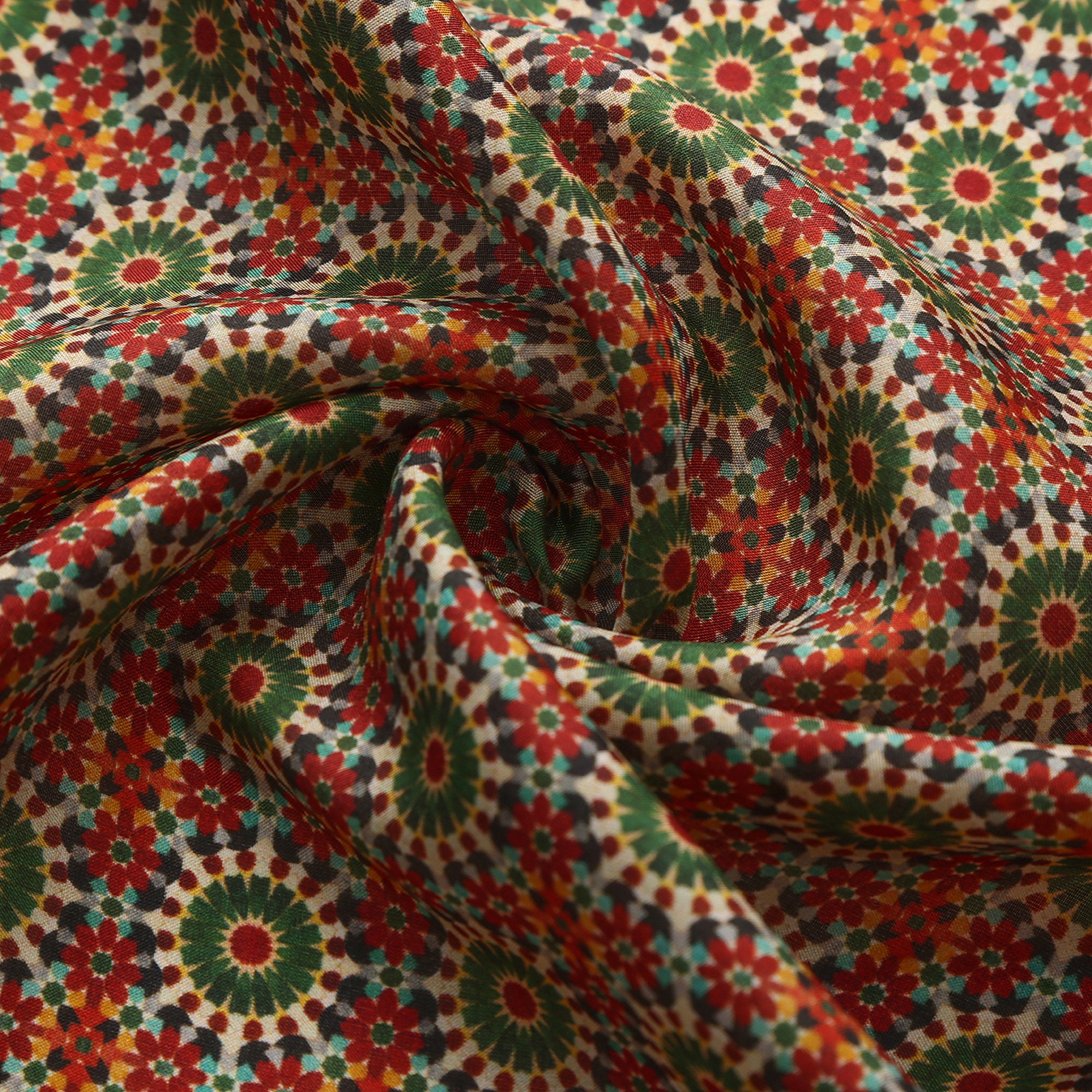 Close-up of the Zubaida silk print: the terracotta and green rosettes on cream