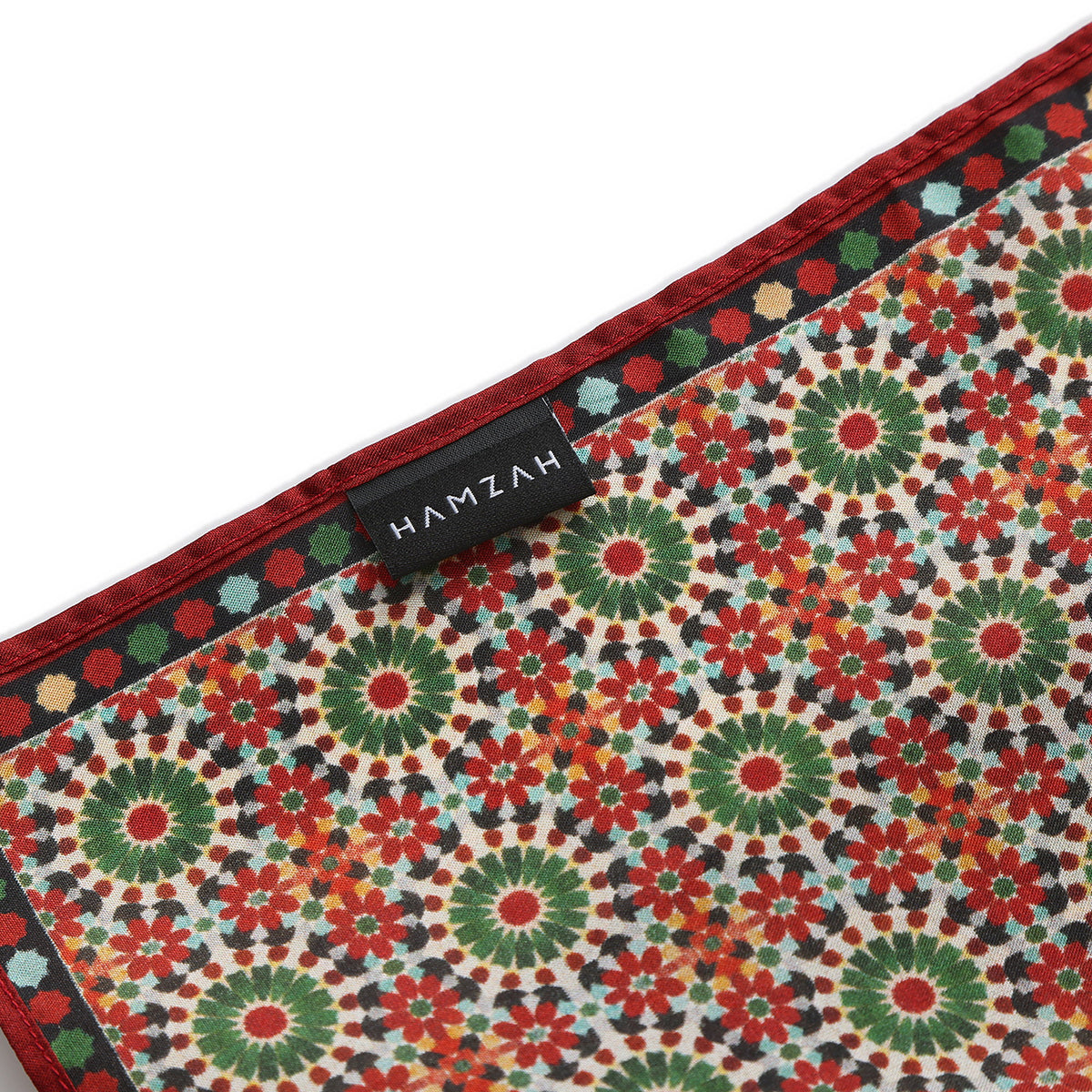Corner of the Red and Green Silk Square Scarf Zubaida with the Hamzah woven label