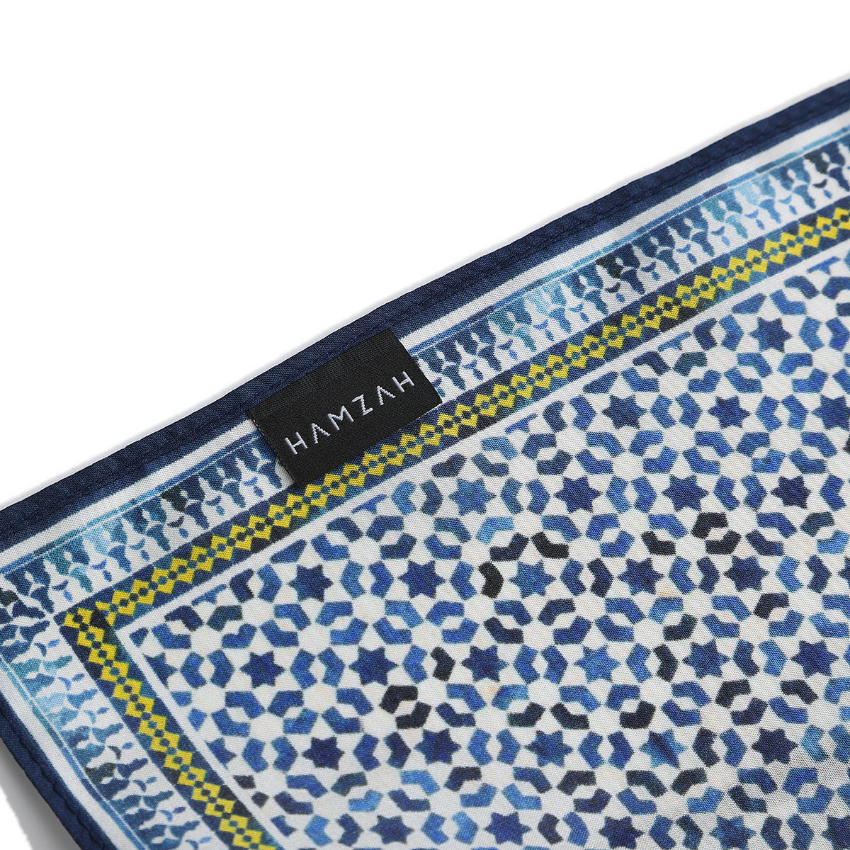 Corner of the Blue Silk Square Scarf Basma with the Hamzah woven label