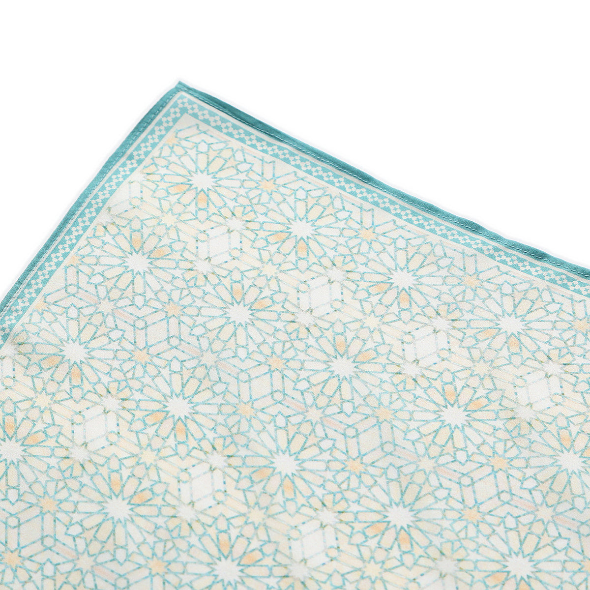 Corner of the Turquoise Silk Square Scarf Lubna with the Hamzah woven label