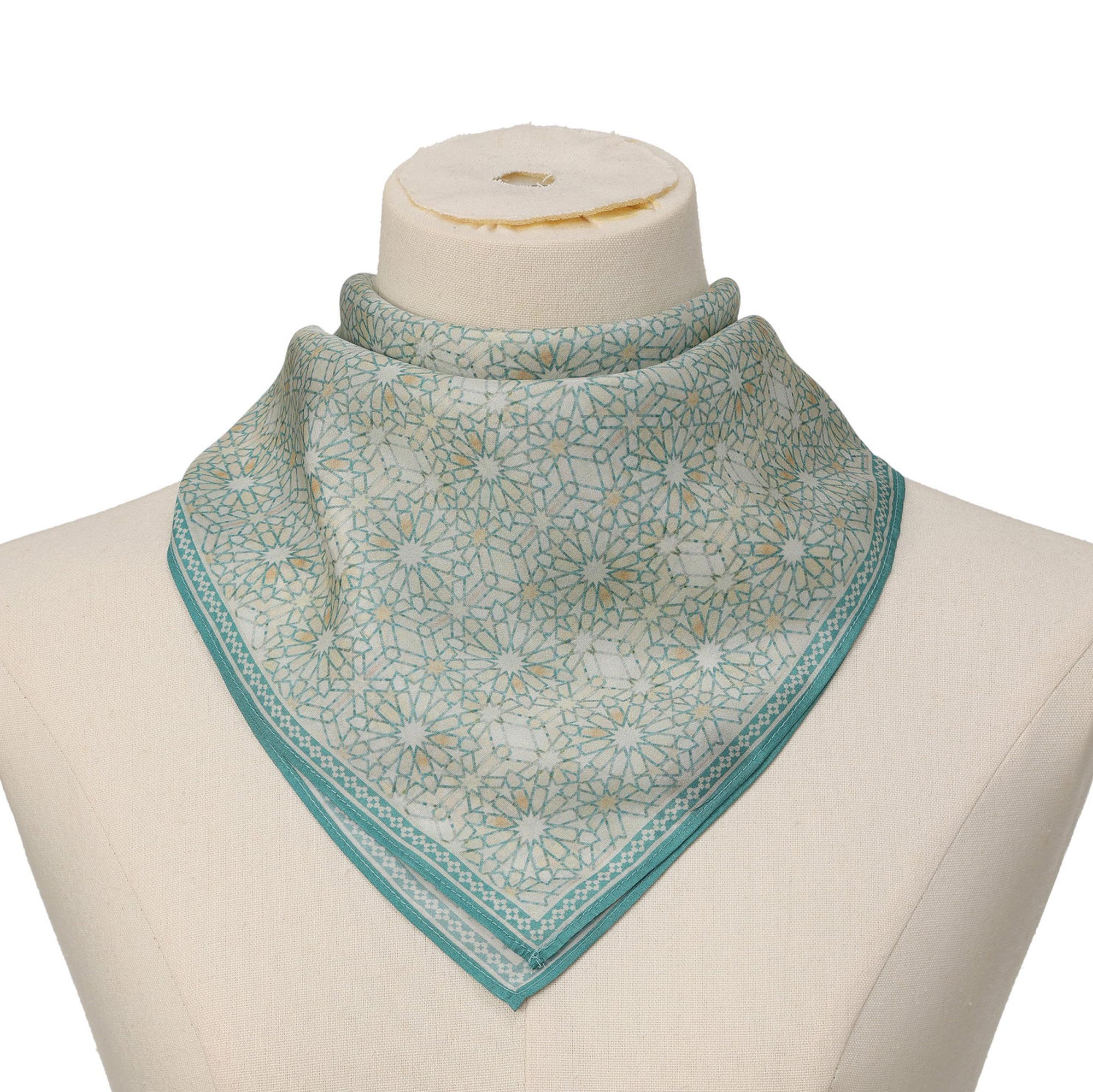 Turquoise Silk Square Scarf Lubna tied at the neck on a mannequin bust