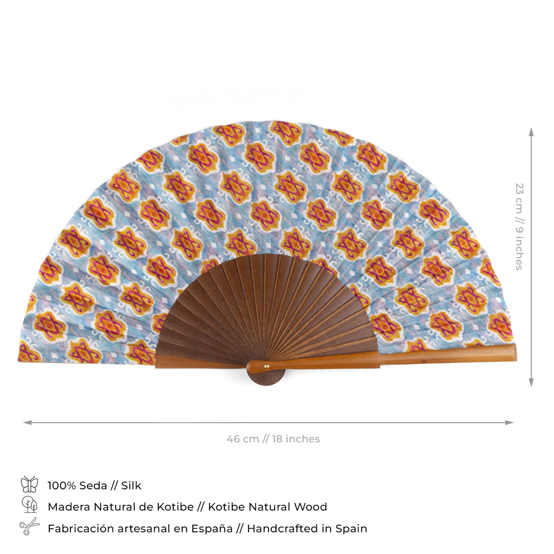The Handcrafted Silk Fan with Geometric Ikat Pattern in Vibrant Colors has a blue, red, and orange design on silk, a brown Kotibe wood base, measures 46 cm by 23 cm, and is expertly handcrafted in Spain.