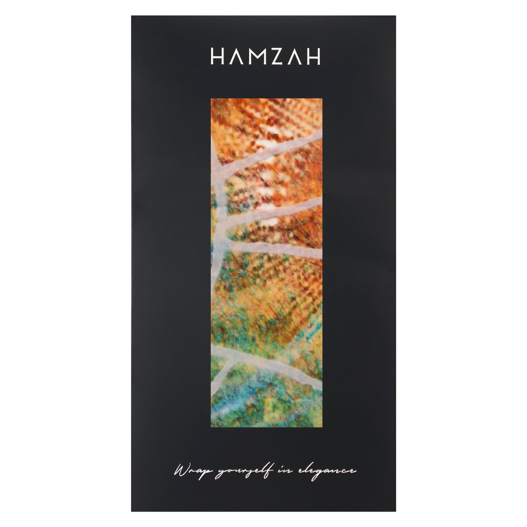 A black rectangular box with HAMZAH at the top, a vertical window revealing the colorful Artisan Silk Scarf Estrellas del Templo inside, and "Wrap yourself in elegance" at the bottom in white cursive text.