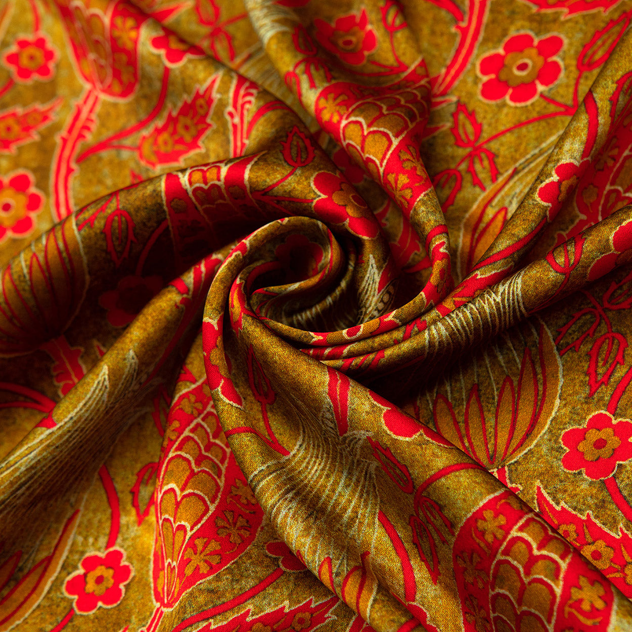 Swirled detail of a floral silk scarf highlighting bold red blossoms, gold stems, and a soft, lustrous finish.