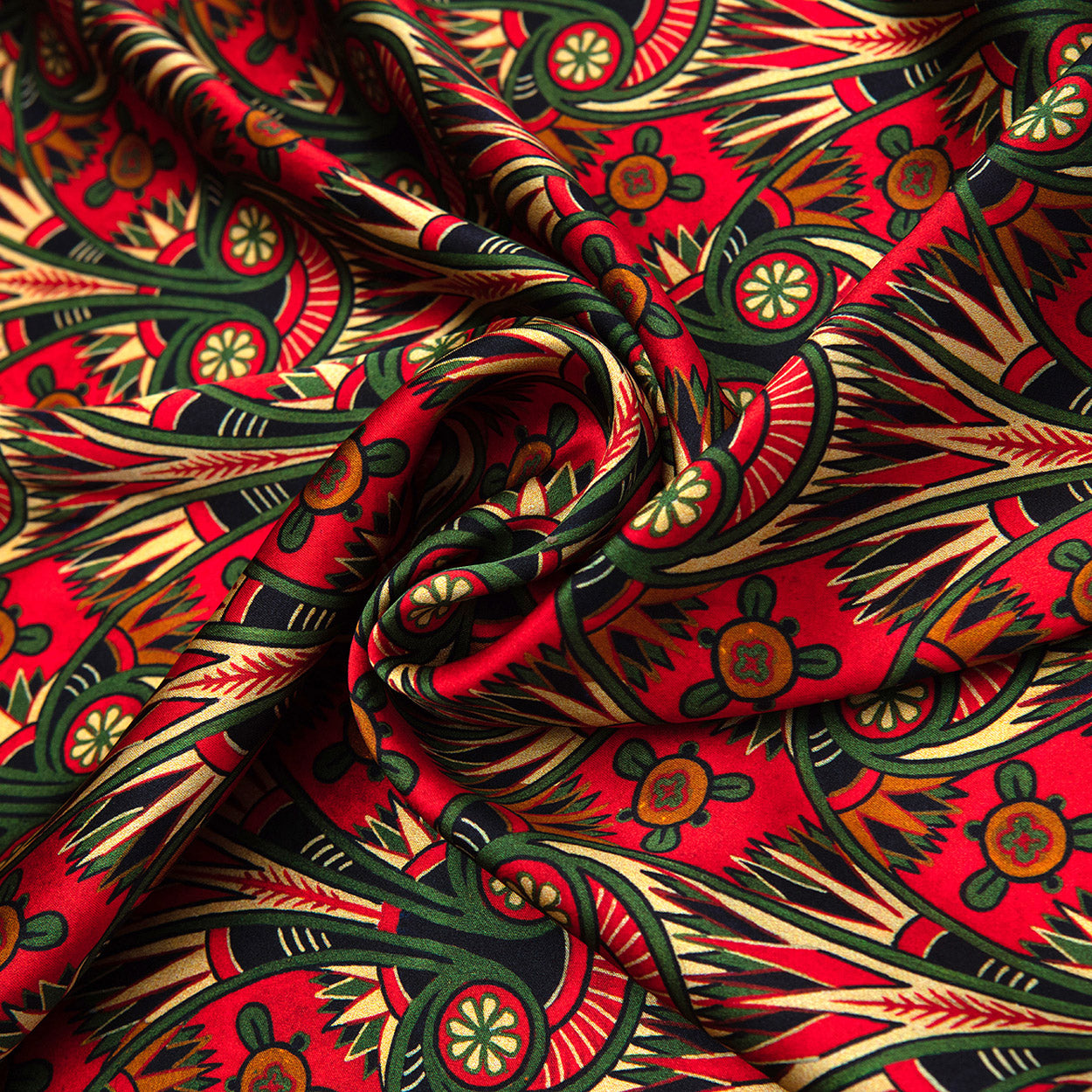 Swirled section of a red art nouveau scarf showcasing ornate green and gold floral elements in a vintage-inspired design.