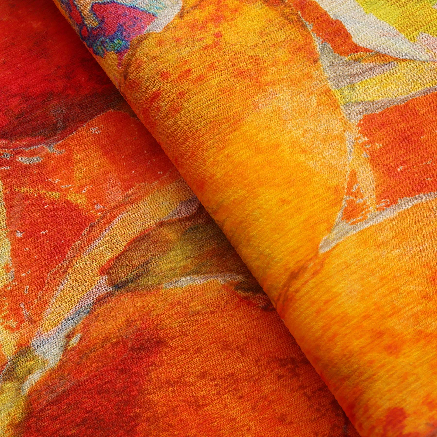 A close-up of the Multicolor Silk Scarf Demeter reveals vibrant orange, yellow, and red abstract patterns—soft blends and overlapping shapes make this muslin silk scarf a stunning piece of wearable art.