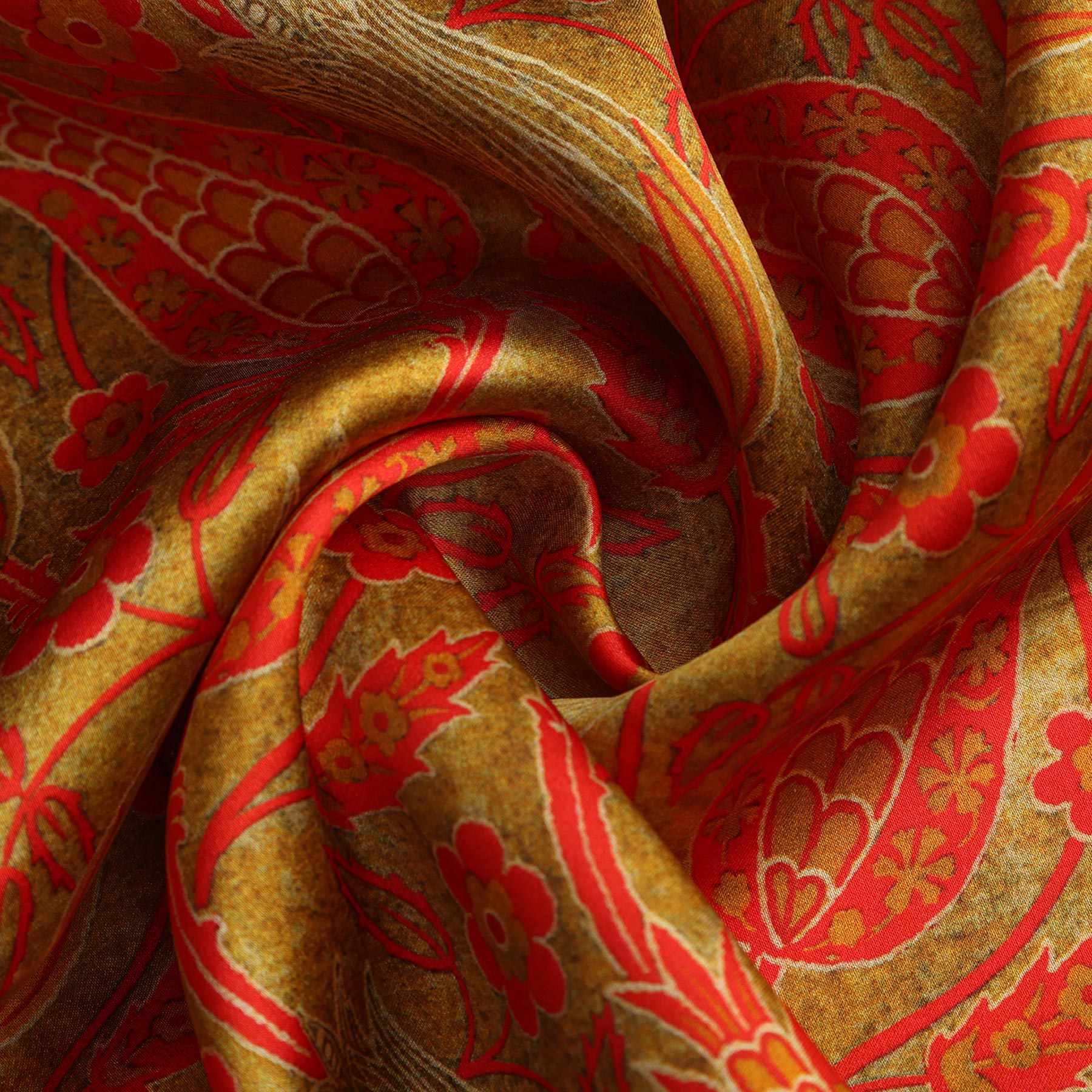 A rectangular HAMZAH box with a vertical window displays the Floral Silk Scarf with Bold Red & Green Accents. Text below says, Wrap yourself in elegance with natural silk.