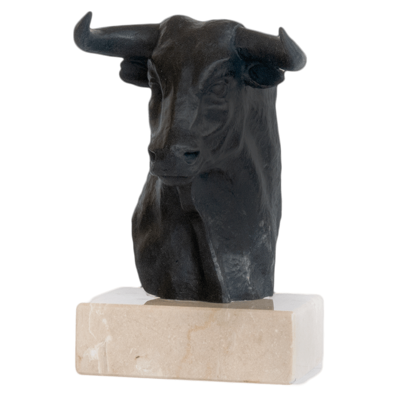 Bronze bull head with dark color on top a light color marble base